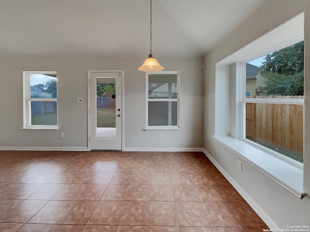 unfurnished dining area featuring light tile patterned floors