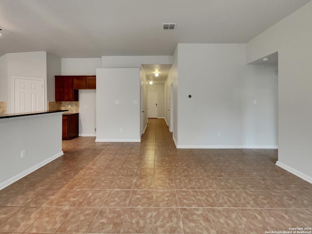 unfurnished living room featuring light tile patterned flooring