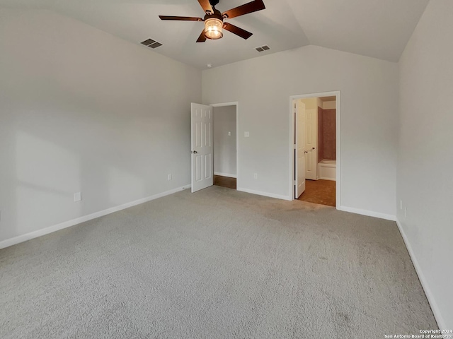 unfurnished bedroom with ceiling fan, lofted ceiling, light carpet, and connected bathroom