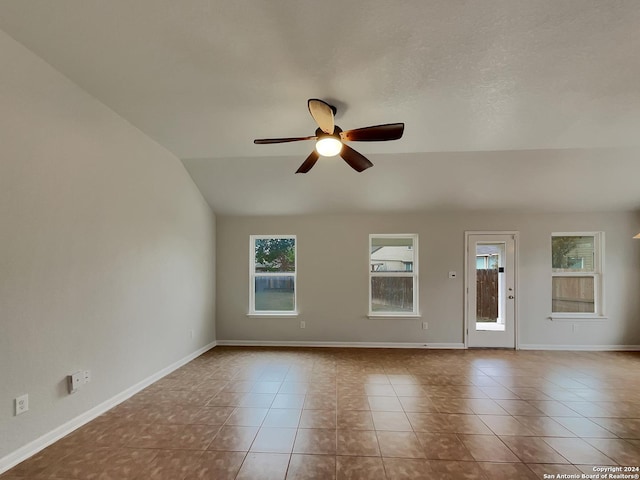 unfurnished room featuring light tile patterned floors, vaulted ceiling, and ceiling fan