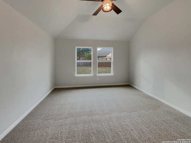 unfurnished room featuring carpet flooring, vaulted ceiling, and ceiling fan