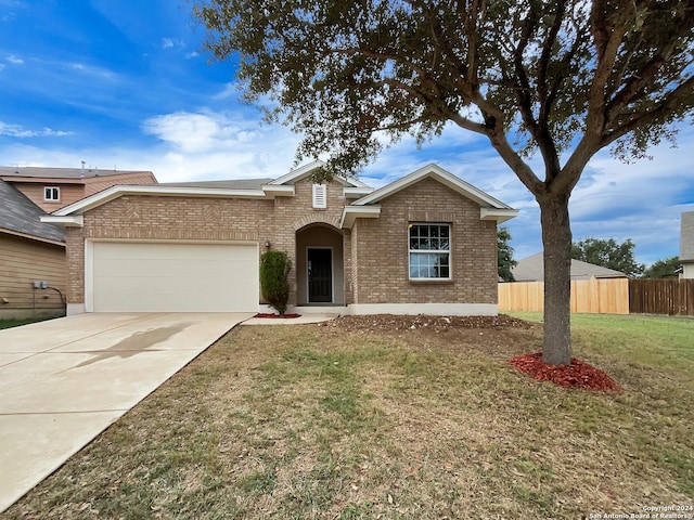 ranch-style house featuring a garage and a front lawn