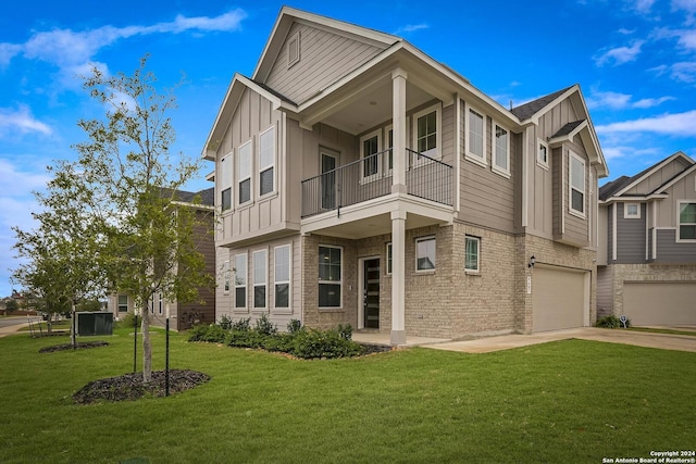 view of front of house with a garage, a balcony, and a front yard