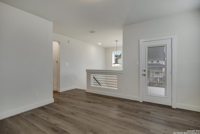 spare room featuring dark hardwood / wood-style flooring