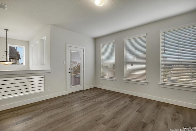 unfurnished room featuring hardwood / wood-style flooring