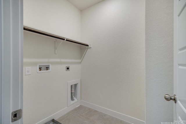 washroom with light tile patterned floors, hookup for a washing machine, and electric dryer hookup