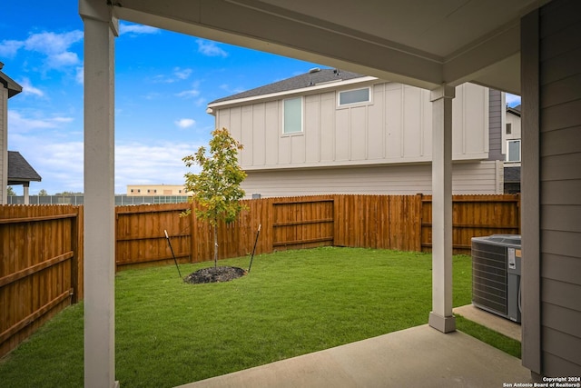 view of yard featuring cooling unit and a patio