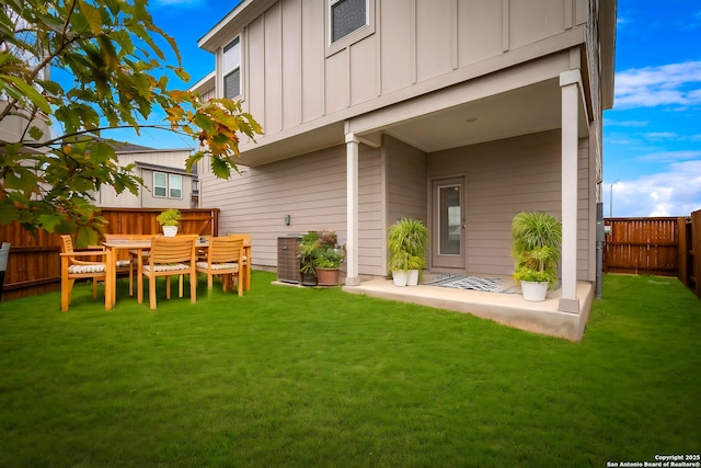 rear view of house with a yard and a patio area