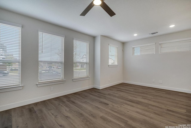 empty room featuring dark wood-type flooring and ceiling fan