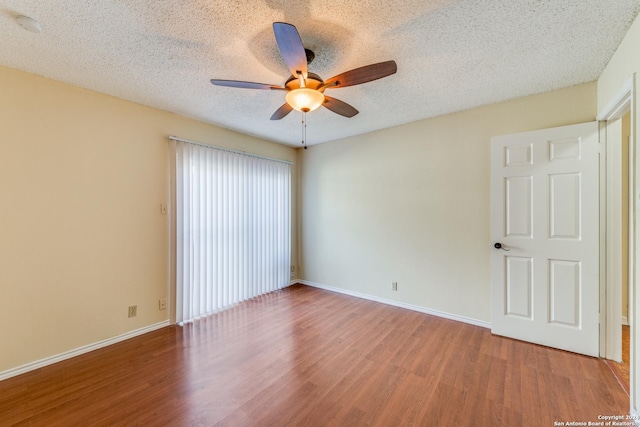 spare room with hardwood / wood-style floors, a textured ceiling, and ceiling fan