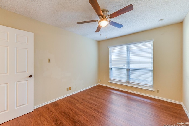 spare room featuring hardwood / wood-style floors, a textured ceiling, and ceiling fan