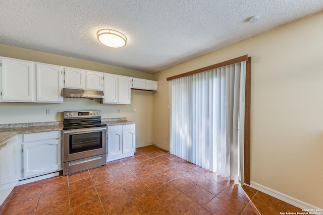 kitchen with electric range, white cabinetry, and a textured ceiling