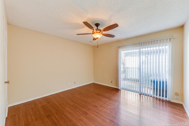 spare room with hardwood / wood-style floors, ceiling fan, and a textured ceiling