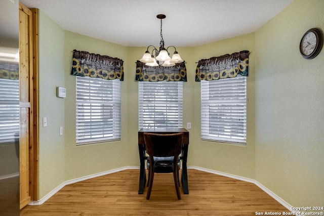 dining room with a notable chandelier and light wood-type flooring