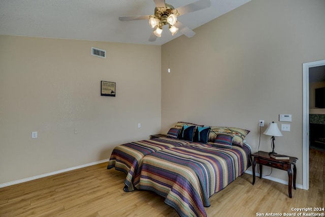 bedroom featuring light wood-type flooring, ceiling fan, and lofted ceiling