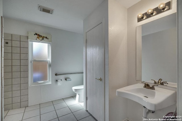 bathroom with tile patterned floors, sink, and toilet