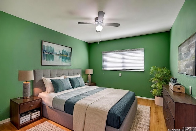 bedroom with ceiling fan and hardwood / wood-style floors