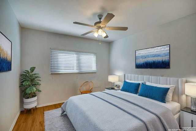 bedroom with ceiling fan and light hardwood / wood-style flooring