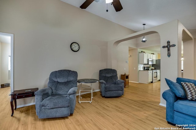 living room with ceiling fan and light hardwood / wood-style flooring