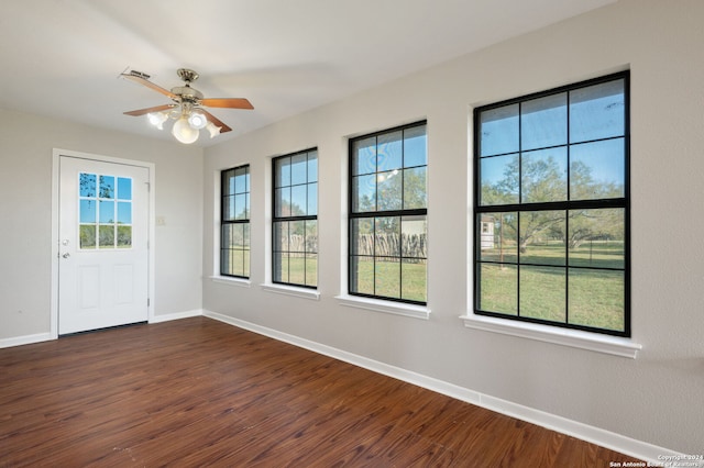 interior space with dark hardwood / wood-style flooring, a wealth of natural light, and ceiling fan