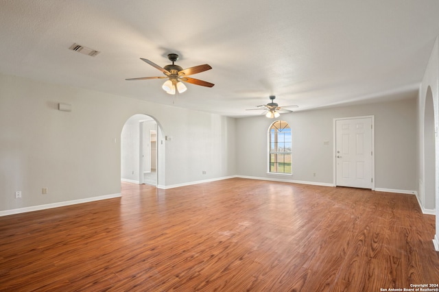 spare room with hardwood / wood-style floors, a textured ceiling, and ceiling fan