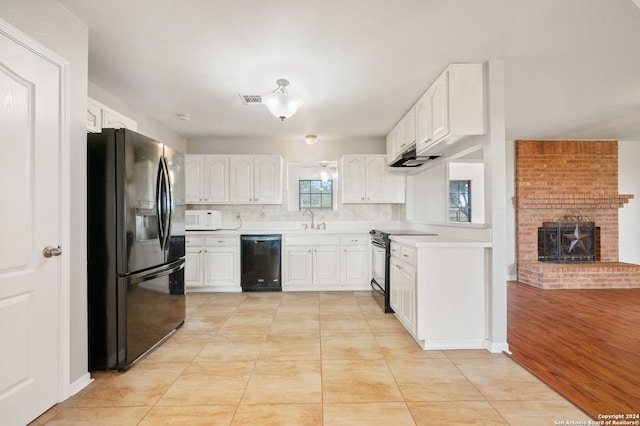 kitchen featuring backsplash, black appliances, white cabinets, sink, and light tile patterned floors