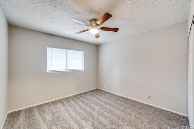 spare room featuring a textured ceiling, carpet floors, and ceiling fan