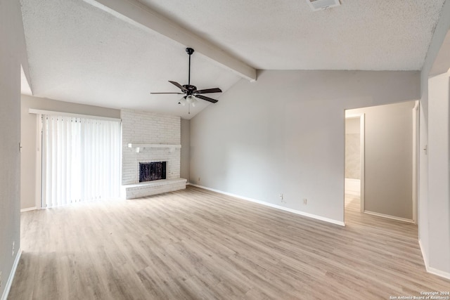 unfurnished living room featuring a fireplace, vaulted ceiling with beams, light hardwood / wood-style flooring, and ceiling fan