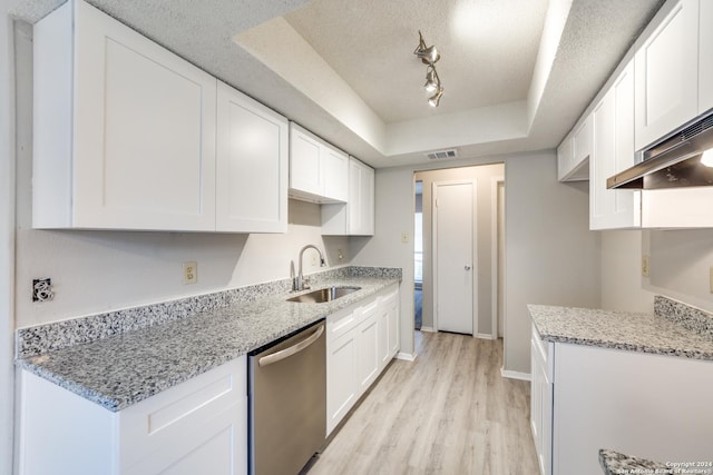 kitchen featuring dishwasher, sink, light hardwood / wood-style flooring, a textured ceiling, and white cabinetry