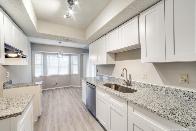 kitchen featuring dishwasher, sink, pendant lighting, white cabinets, and light wood-type flooring