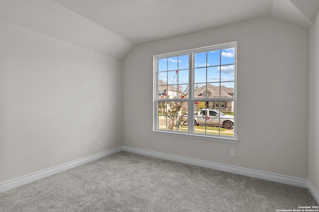 empty room with carpet and lofted ceiling