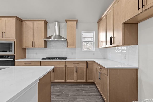 kitchen with backsplash, wall chimney exhaust hood, dark hardwood / wood-style floors, and appliances with stainless steel finishes