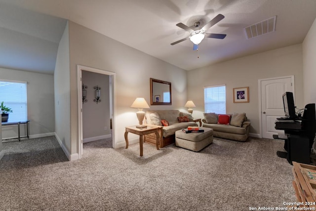 living room featuring carpet, a wealth of natural light, and ceiling fan