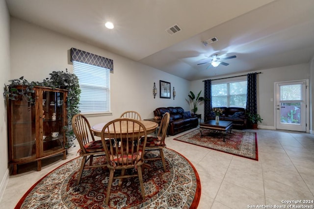 tiled dining area featuring ceiling fan and lofted ceiling