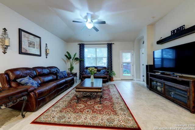 tiled living room with ceiling fan