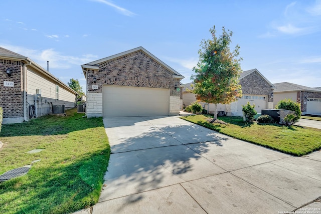 view of front of home featuring a garage, central air condition unit, and a front lawn