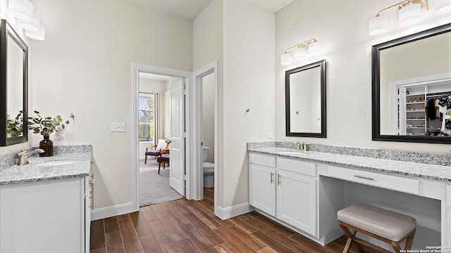 bathroom featuring hardwood / wood-style floors, vanity, and toilet