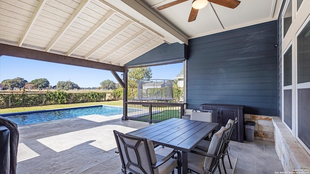 view of patio featuring a fenced in pool, ceiling fan, and a trampoline