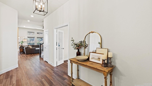 hallway featuring dark hardwood / wood-style floors and a notable chandelier