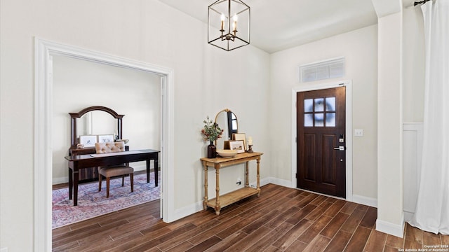 entryway with dark hardwood / wood-style flooring and a chandelier