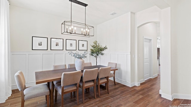 dining area featuring dark hardwood / wood-style floors and a notable chandelier