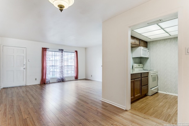 kitchen with light wood-type flooring and white appliances