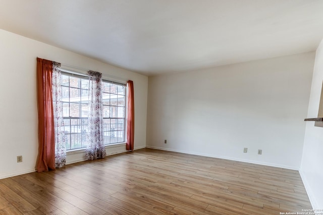 spare room featuring light wood-type flooring