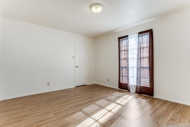 empty room with light hardwood / wood-style flooring