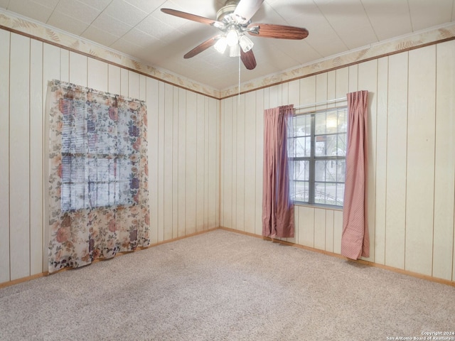 carpeted empty room featuring ceiling fan and ornamental molding