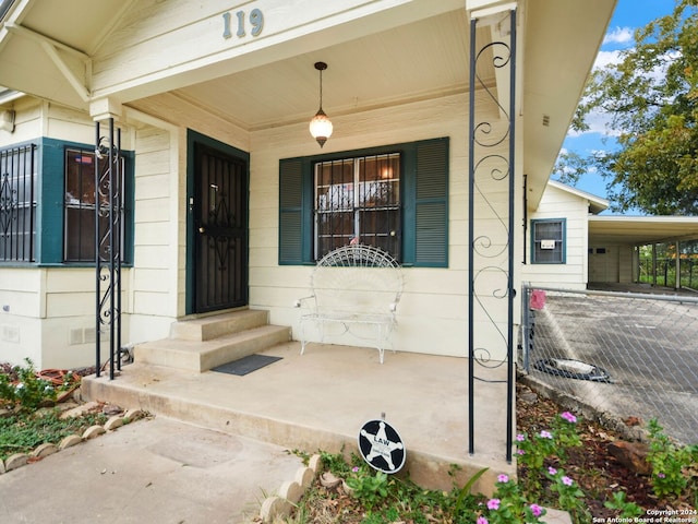 view of exterior entry with covered porch