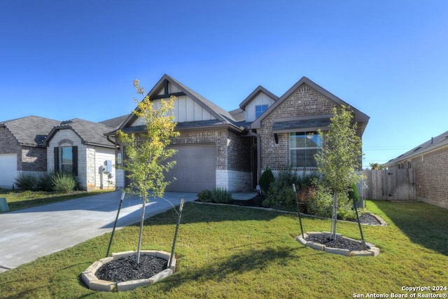 view of front of property with a front yard and a garage