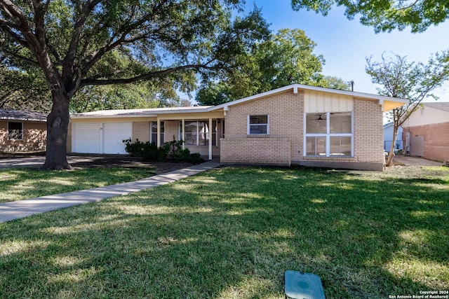 single story home with a front yard and a garage