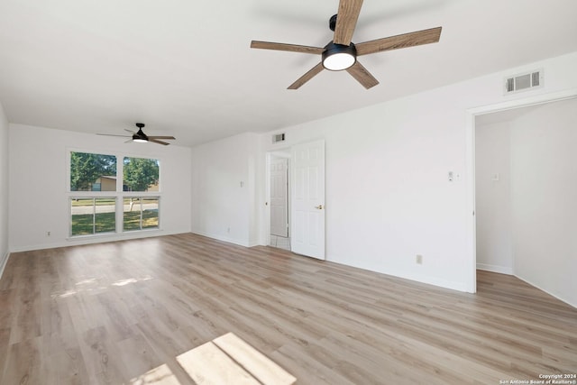 empty room with ceiling fan and light wood-type flooring