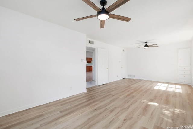 spare room with ceiling fan and light hardwood / wood-style flooring